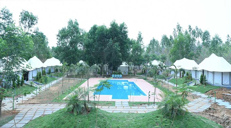 Swimming pool and safari tents at Century Resort Dandeli