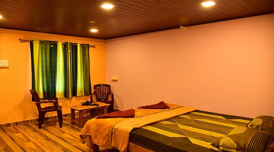 Cottage bedroom at Dandeli River Edge Resort