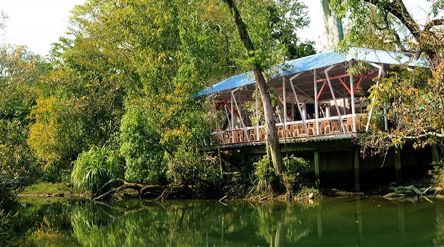 Riverside pavilion dining hall at Whistling Woods River Resort Dandeli
