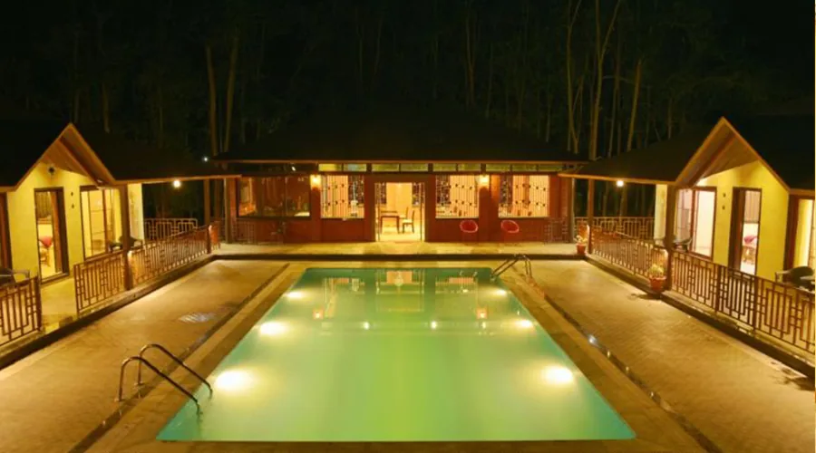 Night swimming pool and cottages at Dew Drops Resort Dandeli