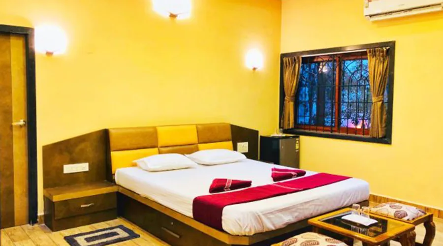 Night view of pool deck at Dew Drops Resort Dandeli