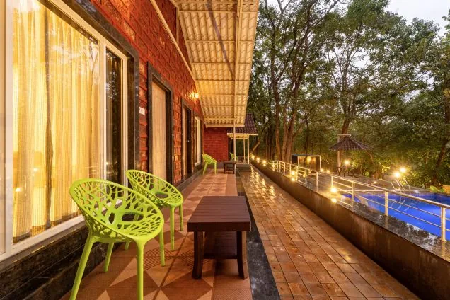 Evening lights on the pool verandah at Jungle View Cottage Dandeli