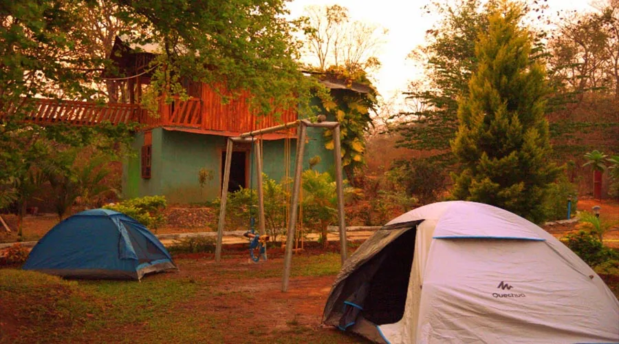 Camping tents and wooden lodge at Rangers Camp Dandeli, Bamanagi