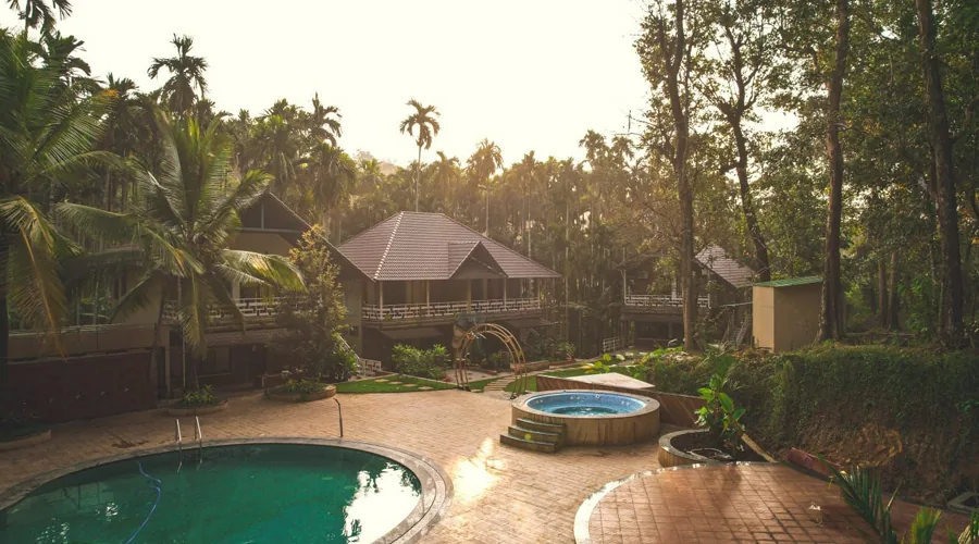 Swimming pool and jacuzzi with forest cottages at Woodpecker Homestay Dandeli